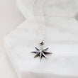 Load image into Gallery viewer, North Star, Starburst pendant in sterling silver on cable chain, on white background. By Studio Blue on Etsy