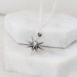 Load image into Gallery viewer, North Star, Starburst pendant in sterling silver on cable chain, on white background. By Studio Blue on Etsy