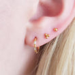 Load image into Gallery viewer, Tiny 3 bead titanium push in flat back stud in 14K Gold Plate shown on model with 3 earrings by Studio Blue on Etsy
