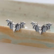 Load image into Gallery viewer, Sterling silver little bat studs on the rim of a sage green dish, by Studio Blue on Etsy