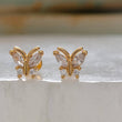 Load image into Gallery viewer, Diamond CZ Butterfly studs in 14k gold plated 316L Surgical steel shown on white background. Screw-in, flat-back nap studs by Studio Blue on Etsy