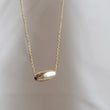 Load image into Gallery viewer, Gold fill oval bead floating on a dainty chain, on a light background, by Studio Blue on Etsy