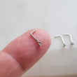 Load image into Gallery viewer, Light Blue Diamond CZ & 14k White gold L-Bend Nose stud, shown on fingertip, by Studio Blue on Etsy