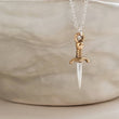 Load image into Gallery viewer, Tiny dagger charm necklace in Sterling silver with Bronze accent on a delicate silver chain by Studio Blue on Etsy.