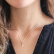 Load image into Gallery viewer, Tiny dagger charm necklace in Sterling silver with Bronze accent on a delicate silver chain by Studio Blue on Etsy.
