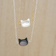 Load image into Gallery viewer, Mother of Pearl cat necklace. White or Black Mother of Pearl carved cat charm on delicate chain, sterling silver and 14k gold fill, by Studio Blue on Etsy