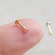 Load image into Gallery viewer, Tiny 2mm dot studs in solid 14k Gold, Screw in flat back nap in earrings on finger by Studio Blue on Etsy