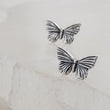 Load image into Gallery viewer, Pair of Sterling silver Butterfly studs earrings shown on white background by Studio Blue on Etsy