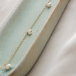 Load image into Gallery viewer, White Baroque pearl drops on delicate 14k gold fill chain, shown on a light green background, by Studio Blue on Etsy
