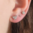 Load image into Gallery viewer, Diamond CZ Butterfly studs in 316L Surgical steel shown on model. Screw-in, flat-back nap studs by Studio Blue on Etsy