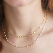 Load image into Gallery viewer, Dainty shimmer chain shown in 14k gold fill along with a longer 14k gold fill chain dotted with white enamel beads by Studio Blue on Etsy