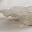 Load image into Gallery viewer, Dainty paperclip link chain necklace in 14k gold fill, shown on shell bowl. By Studio Blue on Etsy