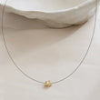 Load image into Gallery viewer, Golden Pyrite Star necklace on black filament, shown on white background by Studio Blue on Etsy