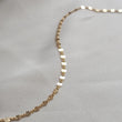 Load image into Gallery viewer, Dainty shimmer chain in 14k gold fill on beige material by Studio Blue on Etsy