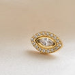 Load image into Gallery viewer, Gold platedTitanium Evil Eye earring stud with pavé set clear CZ's around a clear, marquise shaped CZ in the center on a cream background byStudio Blue on Etsy