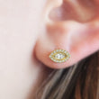 Load image into Gallery viewer, Gold plated Titanium Evil Eye earring stud shown on ear. By Studio Blue on Etsy