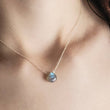 Load image into Gallery viewer, Faceted labradorite necklace in sterling silver on human female model with dark brown hair - By Studio Blue
