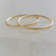 Load and play video in Gallery viewer, Sleeper Hoops • Thin Gold Hoop Earrings • Continuous Hoops • Endless Hoops • Comfort Hoops • Leave In Hoops • 20 Gauge • Delicate Jewelry