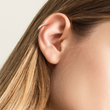 Load image into Gallery viewer, Blonde model with one gold pave hoop in cartilage