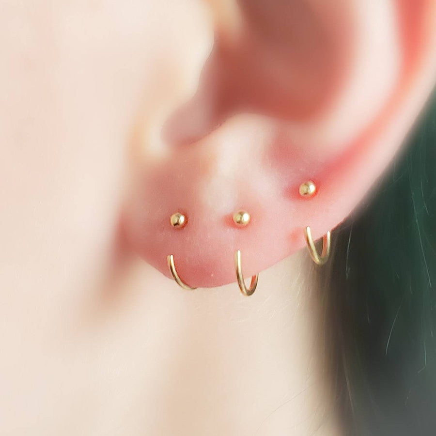 3 yellow gold open hoops with 2mm ball beads on ear