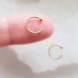 Load image into Gallery viewer, Yellow gold open hoops with 2mm ball beads one on index finger on white background