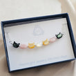 Load image into Gallery viewer, Bracelet with colorful cat-shaped beads in a branded box
