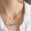 Load image into Gallery viewer, Necklace with colorful cat-shaped beads on a person wearing a white shirt.
