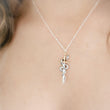 Load image into Gallery viewer, Model wearing the Snake &amp; Dagger Necklace without birthstone accent, displaying the pendant’s balanced design and refined edge against a simple neckline for everyday statement wear.
