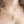 Load image into Gallery viewer, The Snake &amp; Dagger Necklace worn on a model’s neck with a red birthstone accent charm, showing how the pendant hangs delicately from a fine silver chain for a striking yet elegant look.
