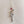 Load image into Gallery viewer, Detailed view of the Snake &amp; Dagger Necklace pendant showing the curved serpent wrapping around the dagger’s blade, crafted in sterling silver with bronze-gold accents for an edgy, statement finish and a red gemstone
