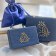Load image into Gallery viewer, Studio Blue’s signature navy-blue jewelry box with satin drawstring pouch, designed for elegant presentation and ready-to-gift packaging.

