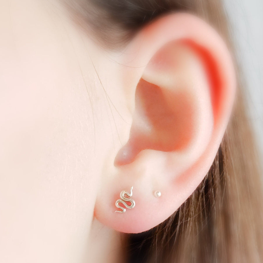 Teeny tiny Snake Studs in Sterling silver on model by Studio Blue on Etsy