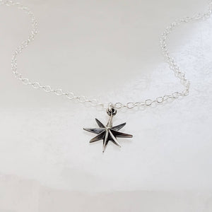 North Star, Starburst pendant in sterling silver on cable chain, on white background. By Studio Blue on Etsy