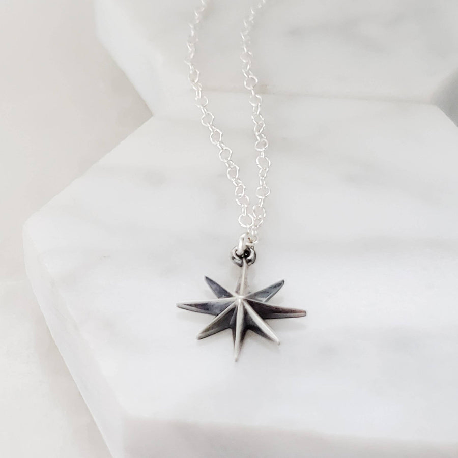 North Star, Starburst pendant in sterling silver on cable chain, on white background. By Studio Blue on Etsy