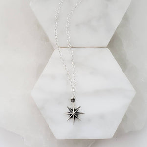 North Star, Starburst pendant in sterling silver on cable chain, on white background. By Studio Blue on Etsy