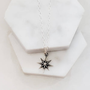 North Star, Starburst pendant in sterling silver on cable chain, on white background. By Studio Blue on Etsy