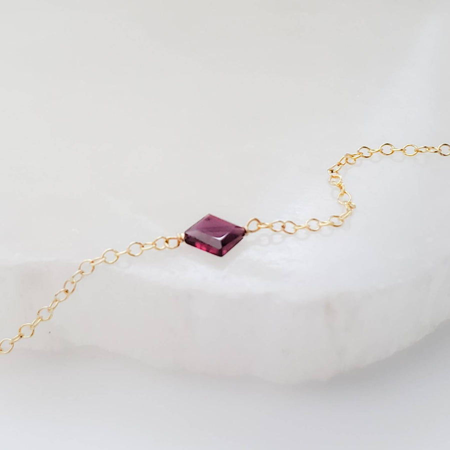 Dainty square cut Garnet bracelet on 14k gold fill cable chain on white background by Studio Blue on Etsy