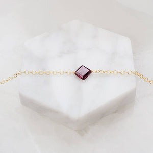 Dainty square cut Garnet bracelet on 14k gold fill cable chain on white background by Studio Blue on Etsy