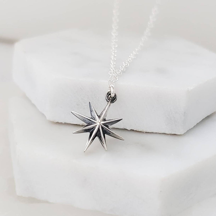 North Star, Starburst pendant in sterling silver on cable chain, on white background. By Studio Blue on Etsy