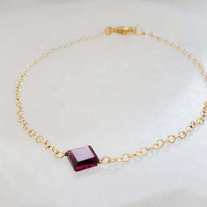 Dainty square cut Garnet bracelet on 14k gold fill cable chain on white background by Studio Blue on Etsy