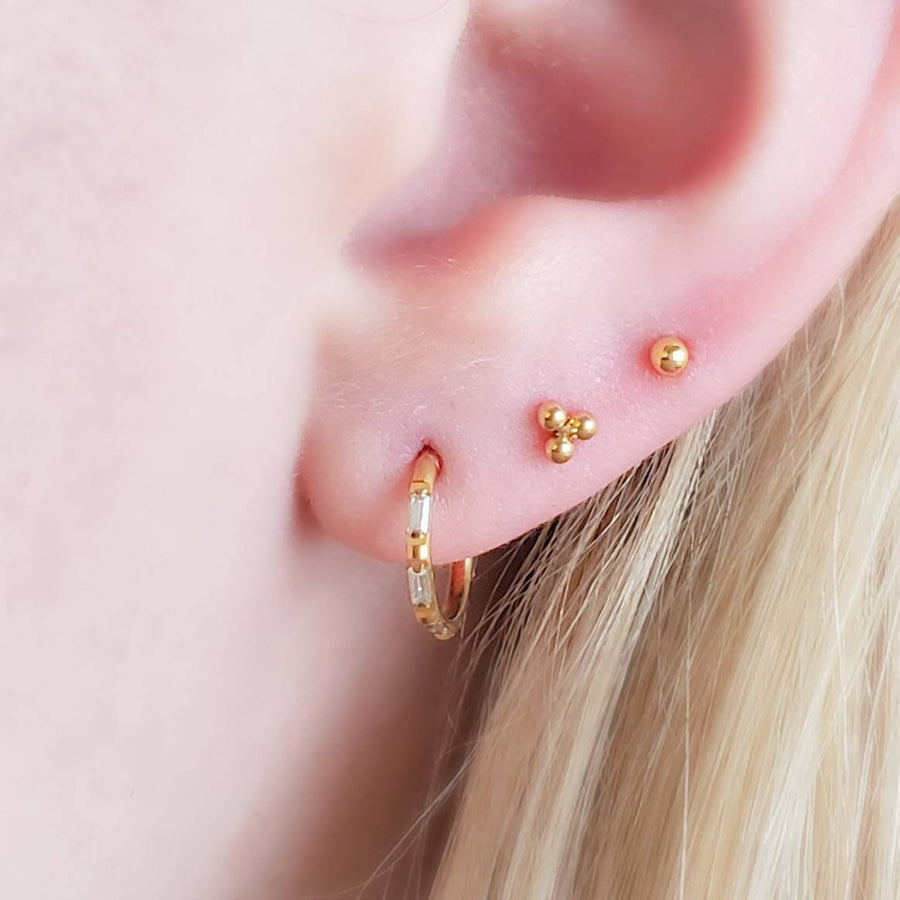 Tiny 3 bead titanium push in flat back stud in 14K Gold Plate shown on model with 3 earrings by Studio Blue on Etsy