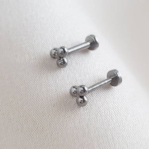 Pair of Tiny 3 bead titanium push in flat back stud shown on white background by Studio Blue on Etsy