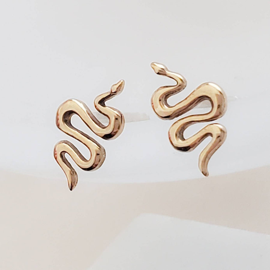 Teeny tiny Snake Studs in Bronze and Sterling silver on white background by Studio Blue on Etsy