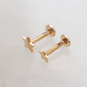 Solid 14K Gold Star studs, overhead shot of the 3mm and 4mm side by side showing the 14k gold hallmark stamp on the posts on white background by Studio Blue on Etsy