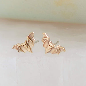 Golden bronze little bat studs on white background, by Studio Blue on Etsy