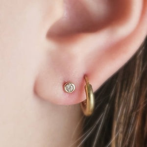 14 karat gold and cubic zirconia push in flat back studs modeled on ear