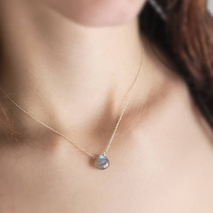 Faceted labradorite necklace in sterling silver on human female model with dark brown hair - By Studio Blue