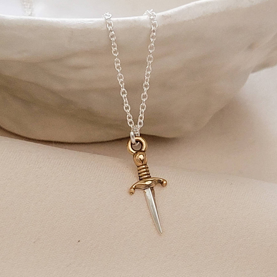 Tiny dagger charm necklace in Sterling silver with Bronze accent on a delicate silver chain by Studio Blue on Etsy.