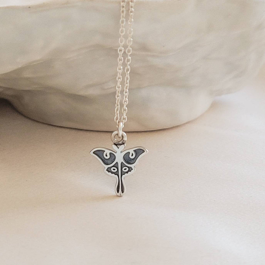 Sterling silver Luna Moth necklace on model by Studio Blue on Etsy