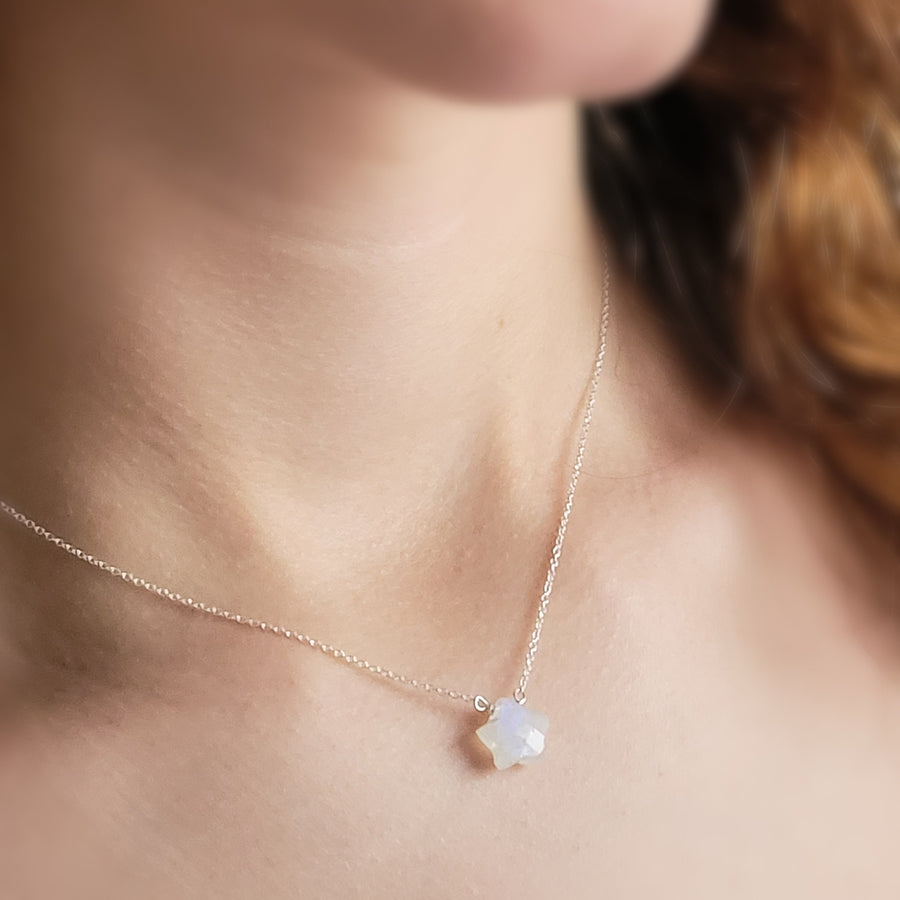 Gemstone star necklace in Rainbow Moonstone with 14k gold fill chain on model, by Studio Blue on Etsy